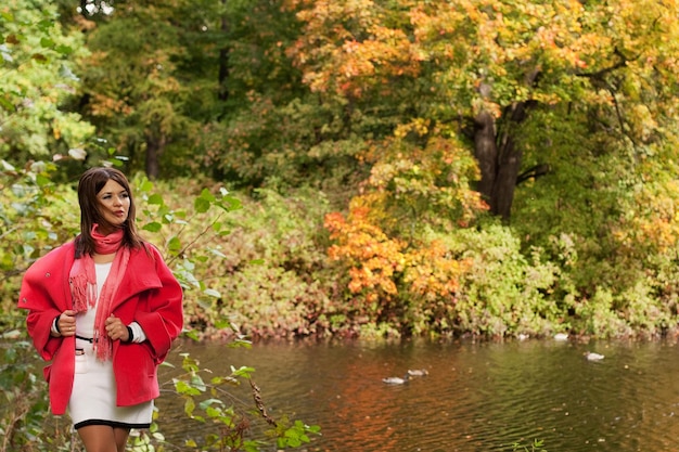 Woman near the river in autumn season