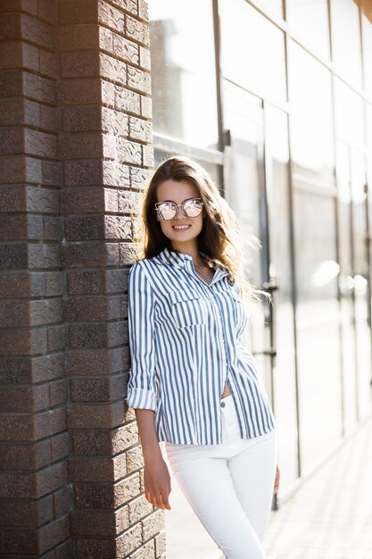 Woman near the wall of a shopping center.