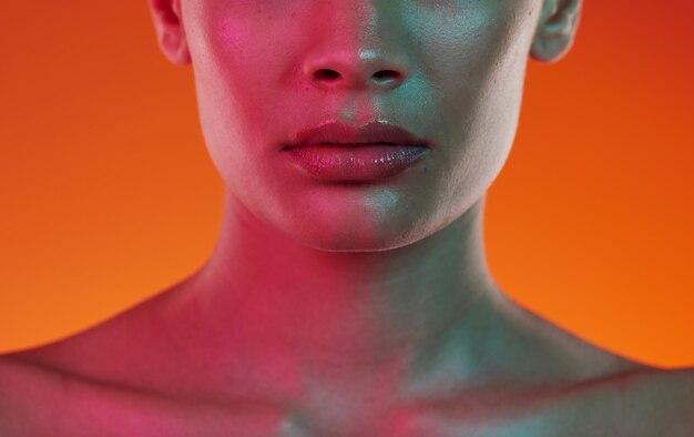 Woman neon beauty and skincare with lips mouth and aesthetic botox cosmetics on color background closeup female model lip filler and face for plastic surgery facial dermatology and cyberpunk art