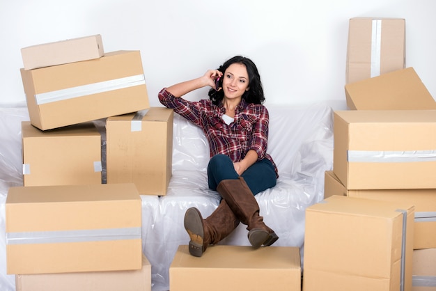 Woman in a new home with cardboard boxes.