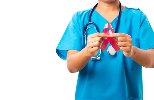 Woman nurse in uniform holding support HIV AIDS awareness red ribbon on hands