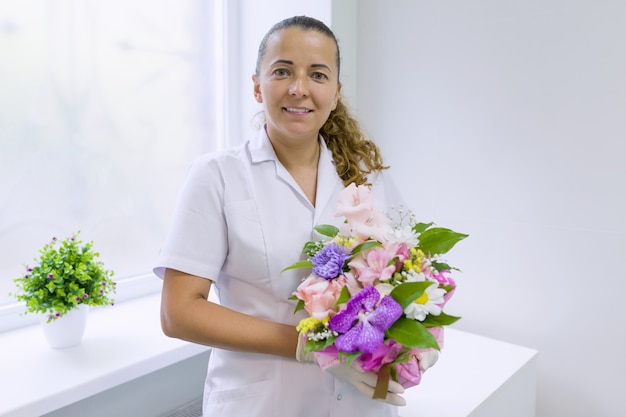 Woman nurse with bouquet of flowers