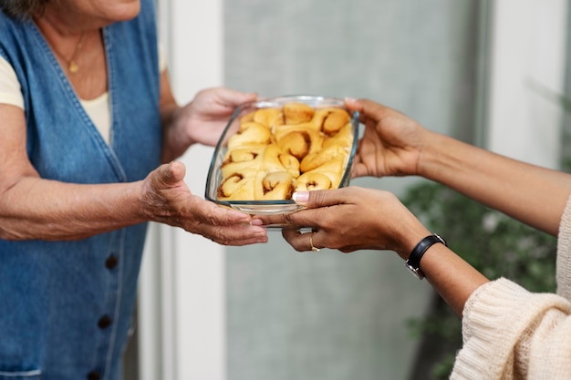 woman offering food to neighbor