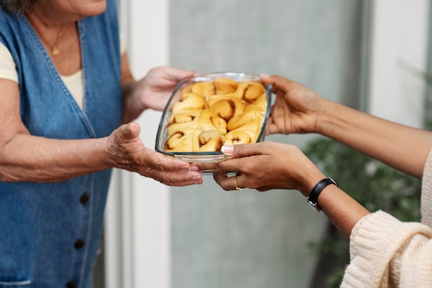 Woman offering food to neighbor