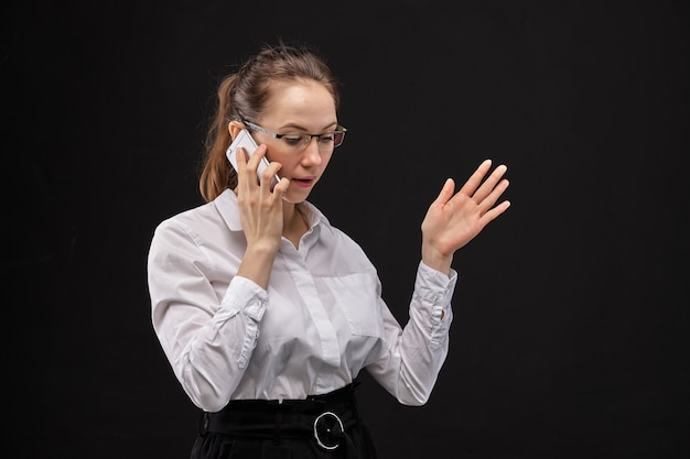 woman office employee speaks on a smartphone.