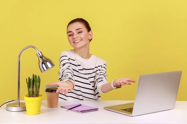 Woman office manager in striped shirt happily greeting new employee raising arms to hug