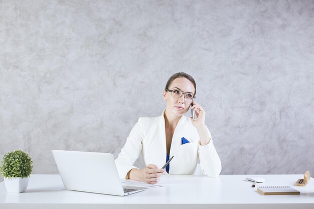 Woman in office on phone