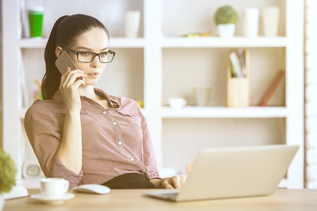 Woman in office talking on phone