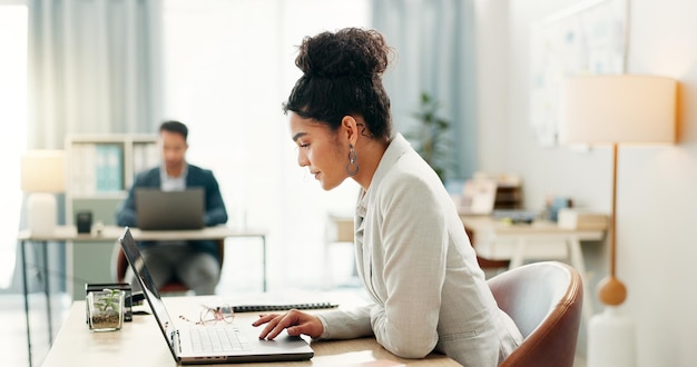 Photo woman in office with laptop typing and market research in at creative agency with internet email and tech administration business people and girl at computer writing review feedback or report