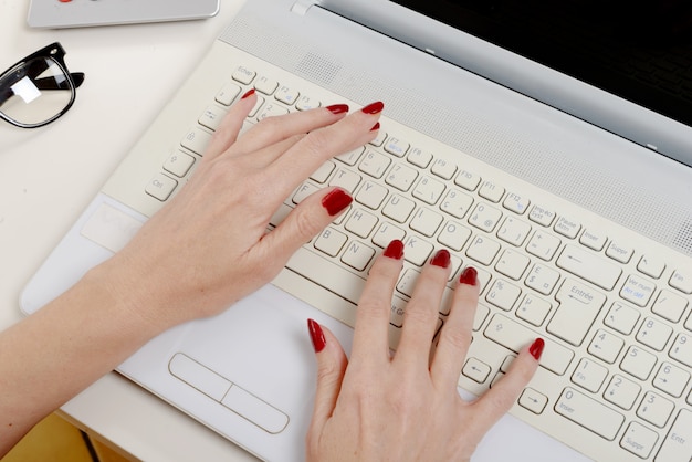 Woman office worker typing on the keyboard