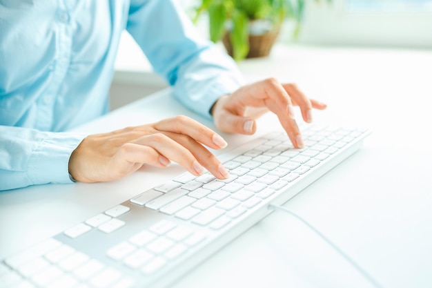 Woman office worker typing on the keyboard