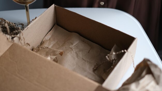 woman opening parcel indoors woman opening and unpacking cardboard box