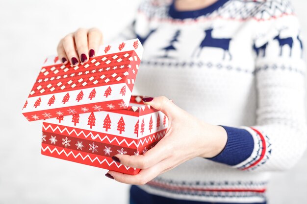 Woman opens a box of gifts