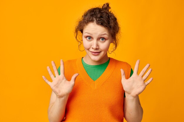 Photo woman in orange sweater fashion youth style studio