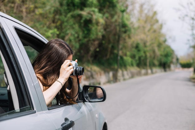 Photo woman out of car window