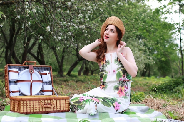 Woman outdoor in dress hat nature