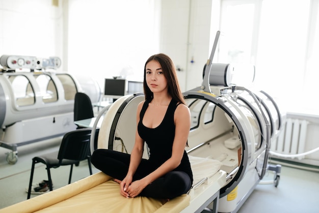 A woman in an oxygen pressure chamber is being treated.\
treatment of pneumonia and covid.