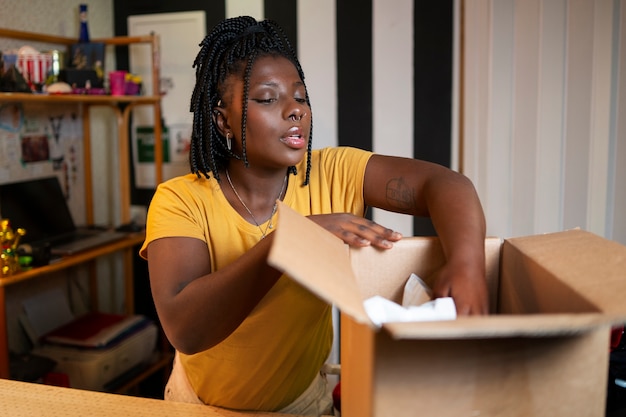 Woman packaging clothing in thrift store