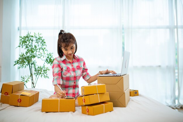 Woman packing boxes for prepare shipping to customer