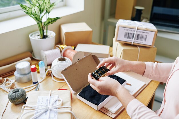 Woman packing handmade jewelry