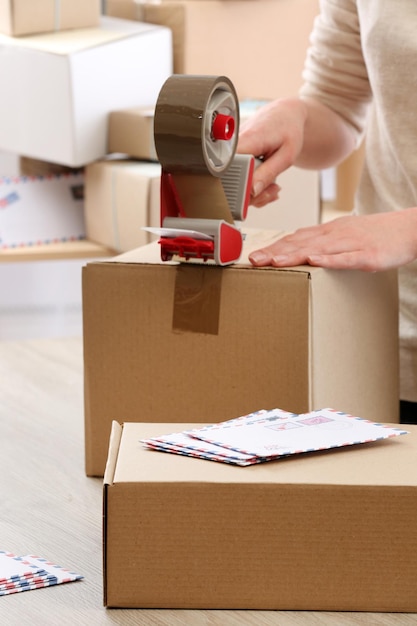 Woman packs parcel in post office