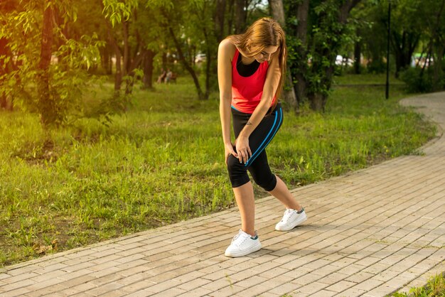 Woman in pain while running in park