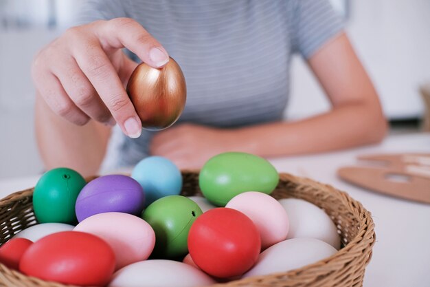 Woman painting Easter eggs at home. family preparing for Easter. 