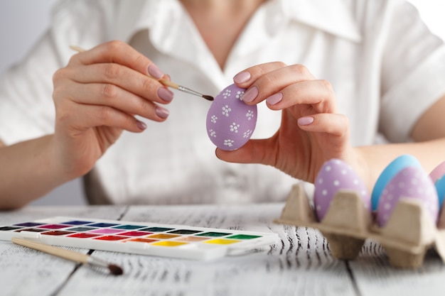 Woman painting Easter eggs