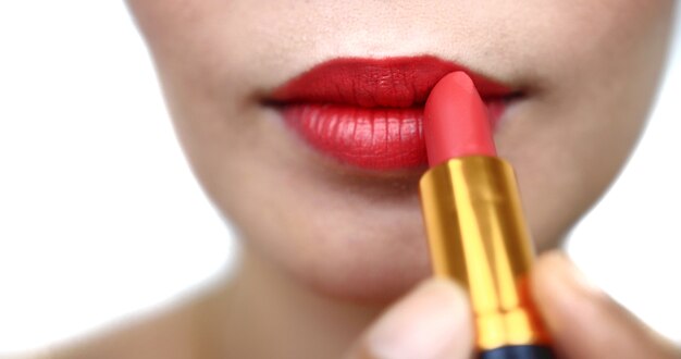 Woman painting a red lipstick