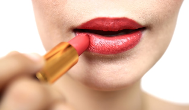 Woman painting a red lipstick