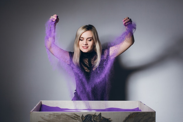 Woman paints on an interactive sand table