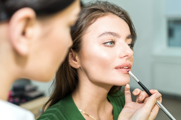 Woman paints the lips