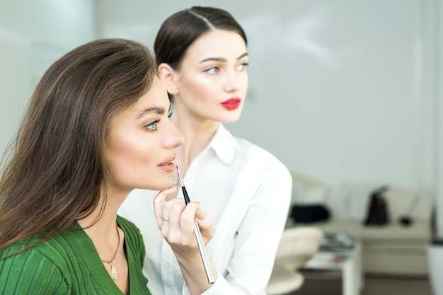 Woman paints the lips