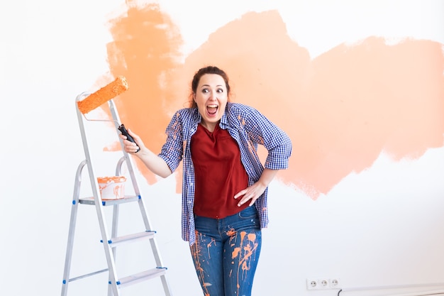 woman paints the wall