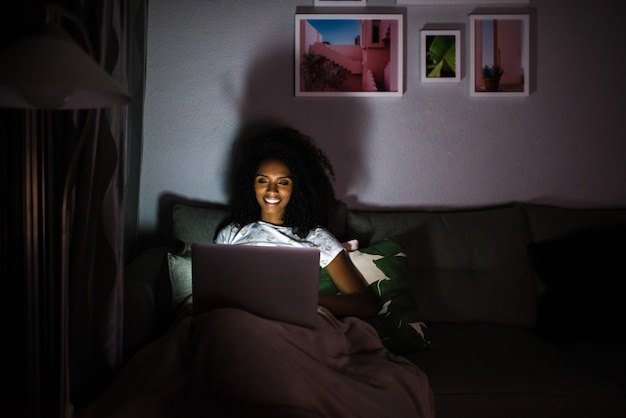 Woman in pajamas with a computer