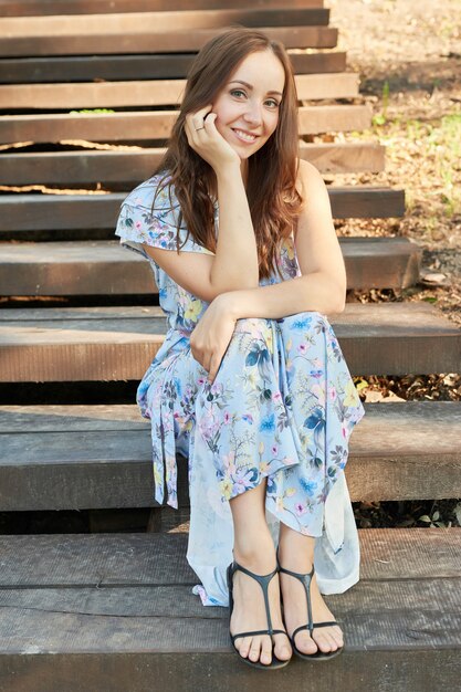 woman in a park sits on the stairs