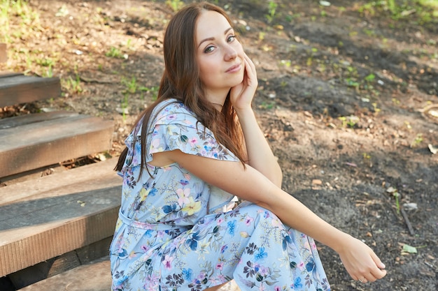 woman in a park sits on the stairs