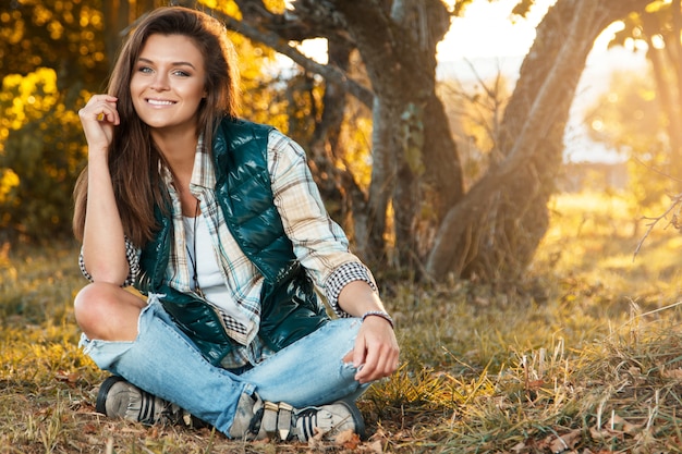 Woman in the park at sunny autumn day