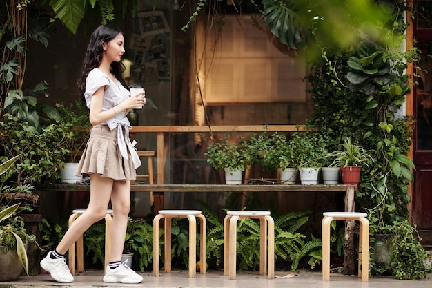 Woman Passing by Coffeeshop