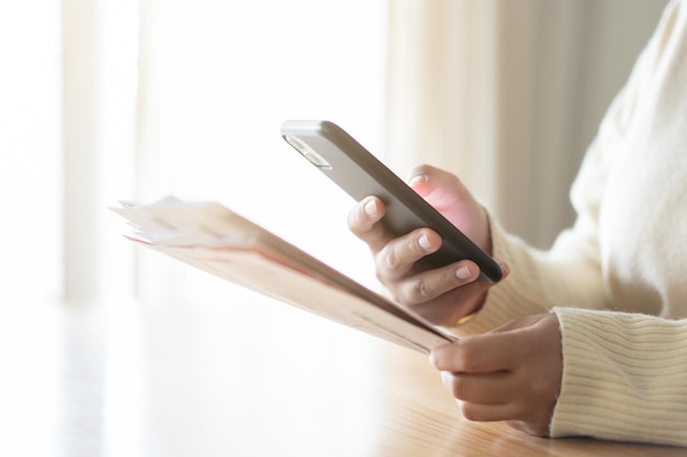 Woman paying bills using mobile phone Cashless payment concept