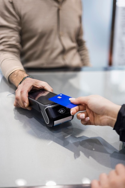 Woman paying contactless with credit card in a shop