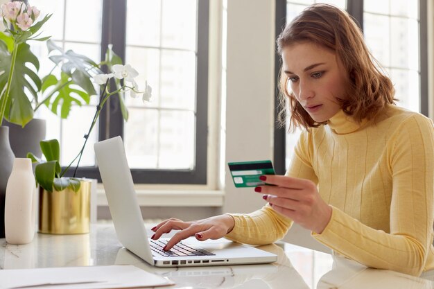 Photo woman pays for online purchases by card