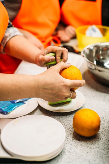 Woman peel an orange with hands