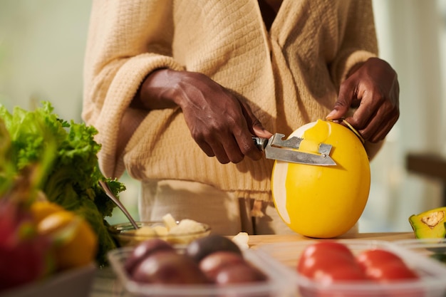 Woman Peeling Melon