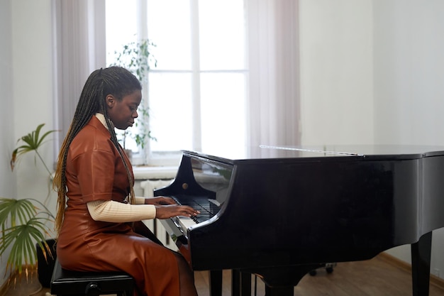 Woman performing on grand piano