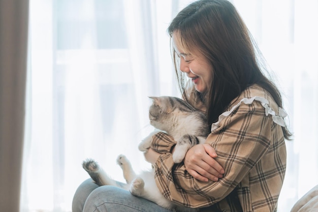 Woman petting cat on the sofa. domestic animal