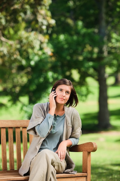 Woman phoning on the bench