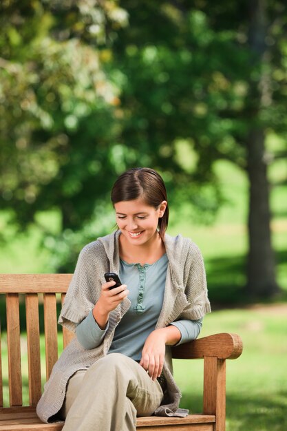 Woman phoning on the bench