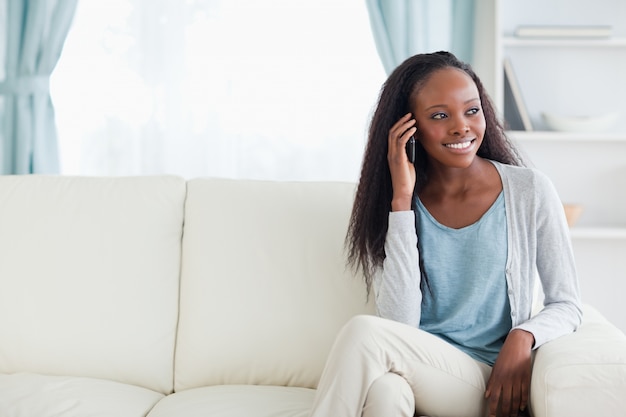 Woman phoning on sofa