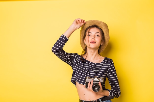 Woman photographer beauty caucasian brunette young girl on yellow background